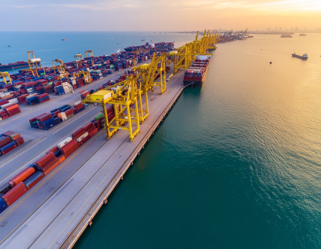 Aerial view of a busy international port with container ships - Logistics Buyer
