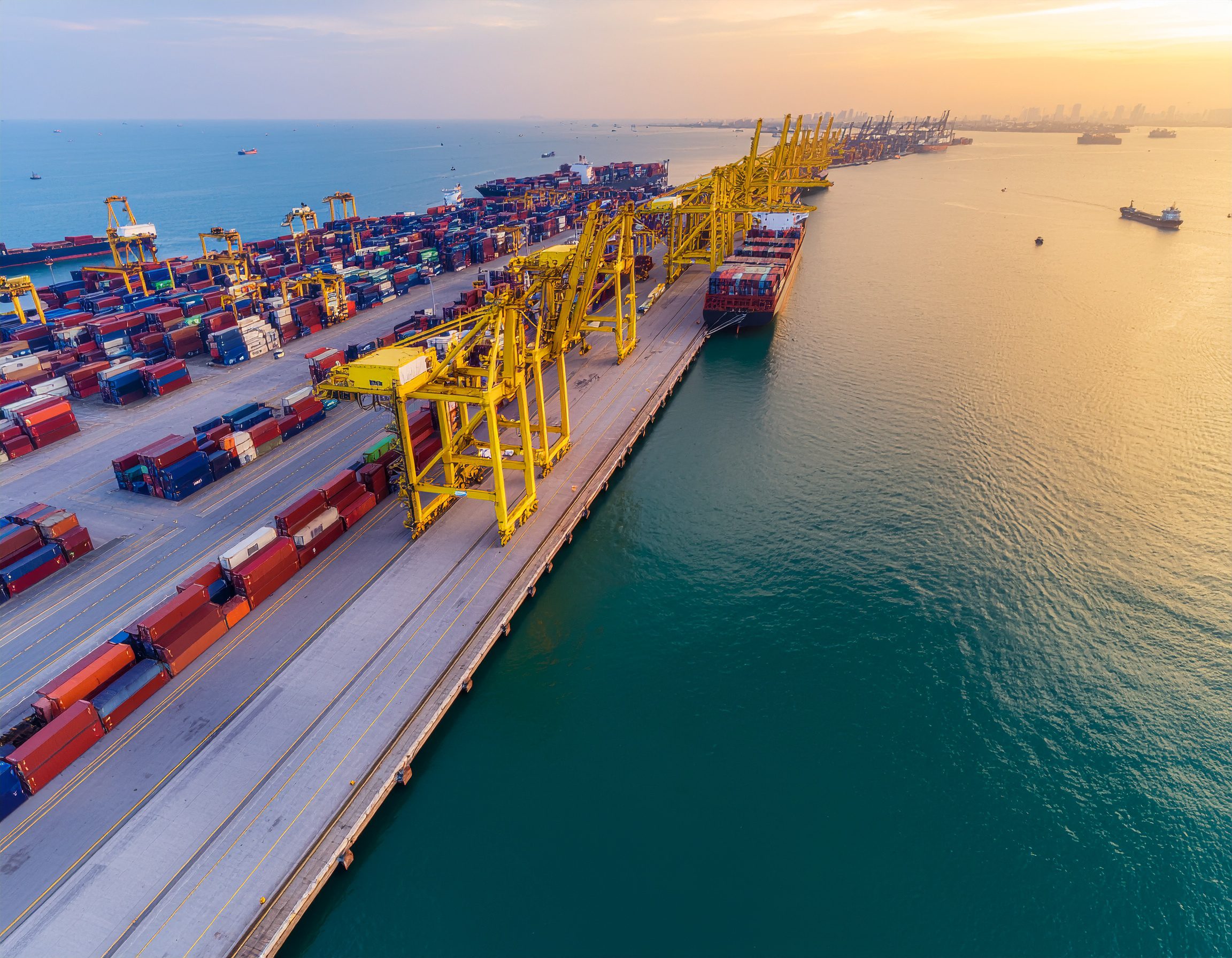 Aerial view of a busy international port with container ships - Logistics Buyer