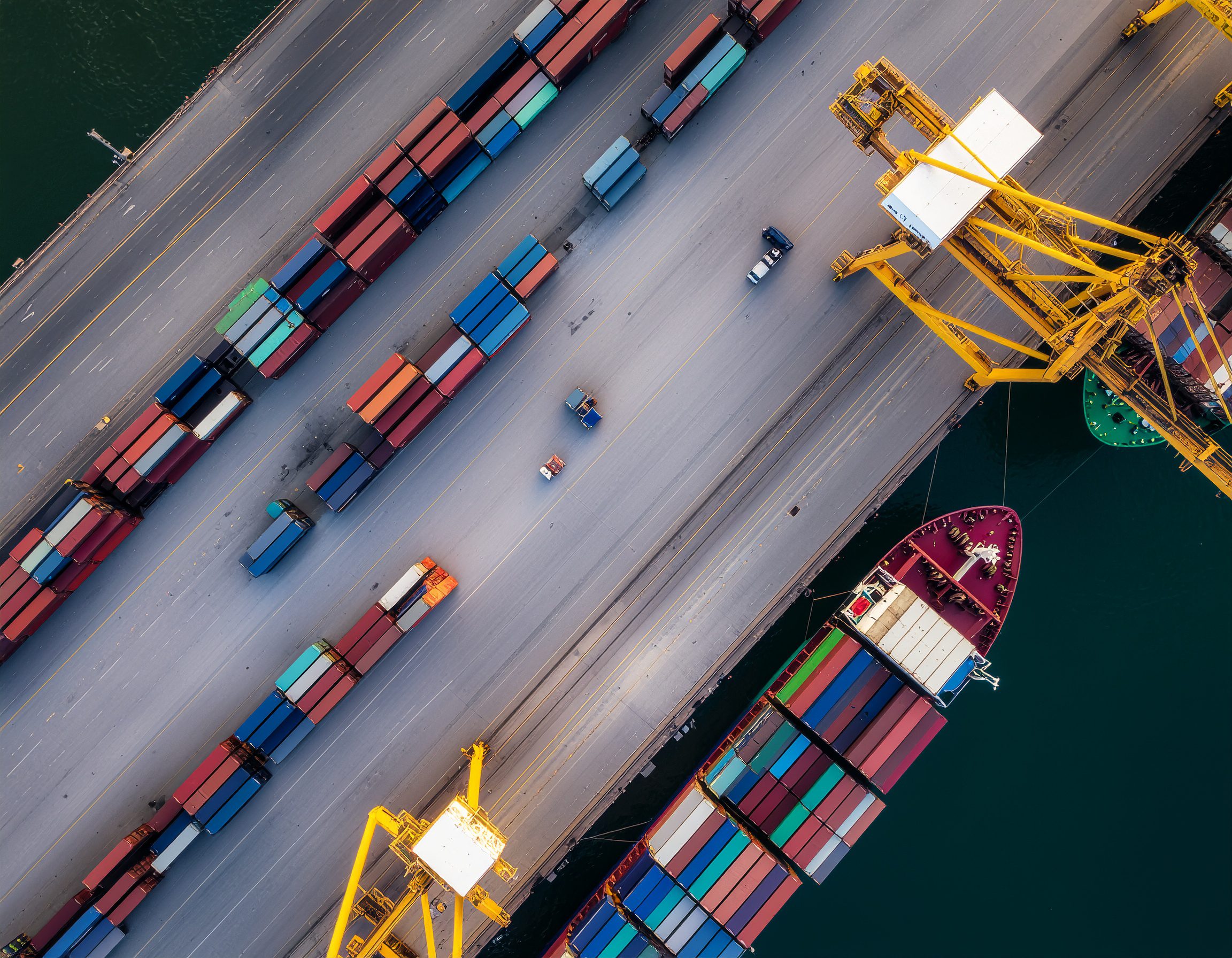 Aerial view of a busy international port with container ships, cranes loading freight - Logistics Buyer