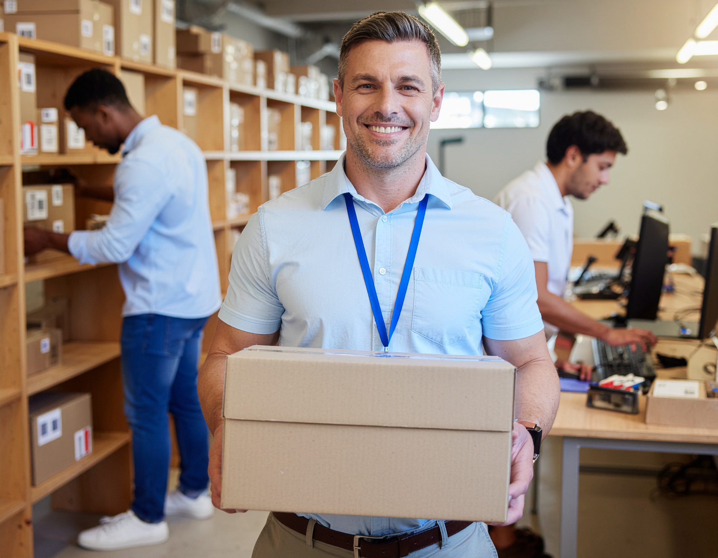 Logistics center team packing and labeling parcels for delivery - Logistics Buyer